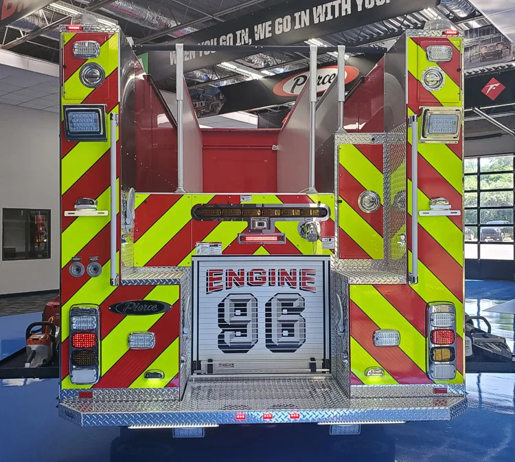 Rear view showing red-and-yellow chevrons and rear door panel