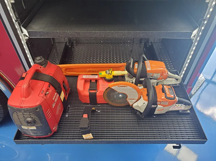 Open compartment close-up showing power tool and accessory storage