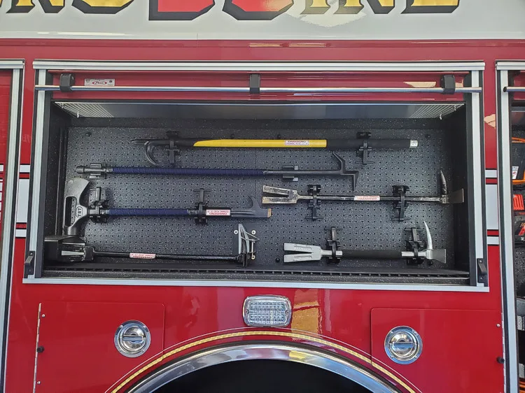 Open side compartment showing mounted hand tools in horizontal rack