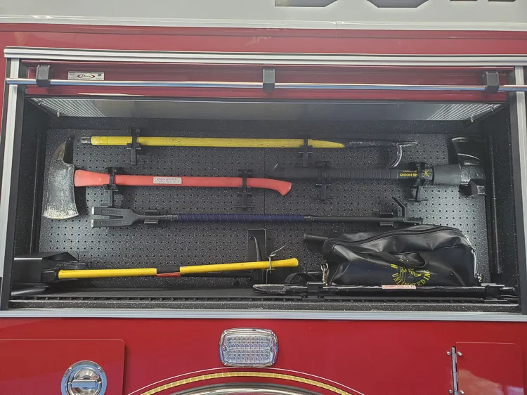 Open side compartment showing long tools and shelf storage