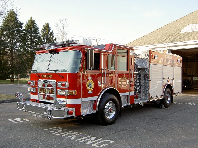 Front-right exterior view showing cab, front wheel, and side compartments