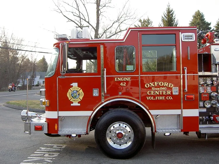 Driver-side cab close-up showing doors, mirrors, and front wheel area