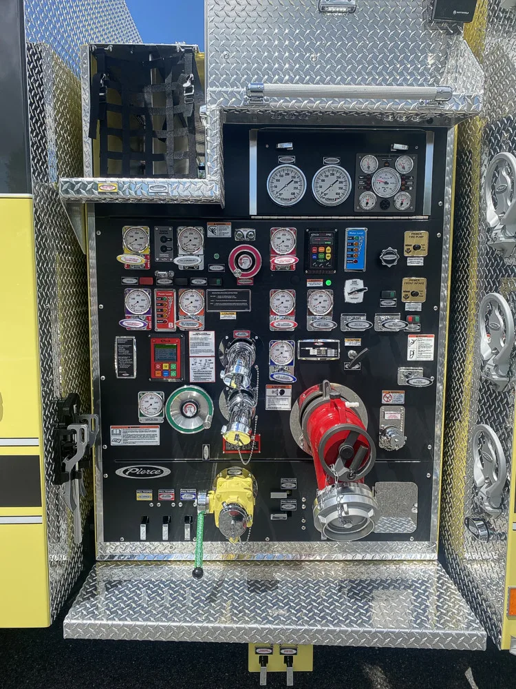 Pump panel close-up showing gauges, valves, and labeled controls