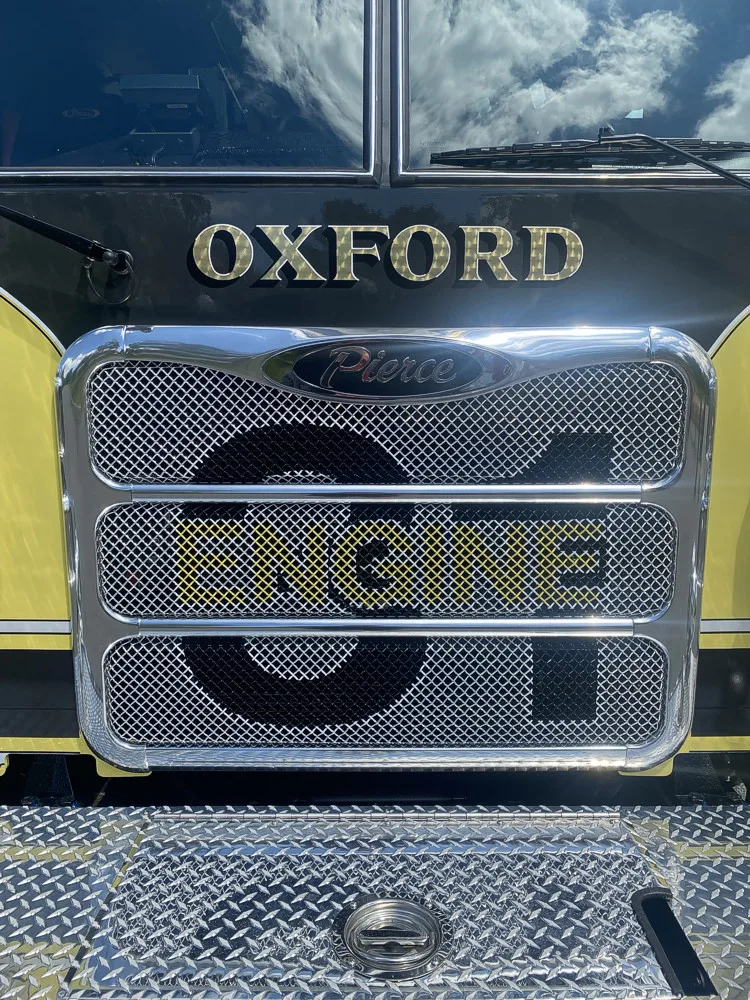 Front grille close-up showing Oxford lettering and centered unit number