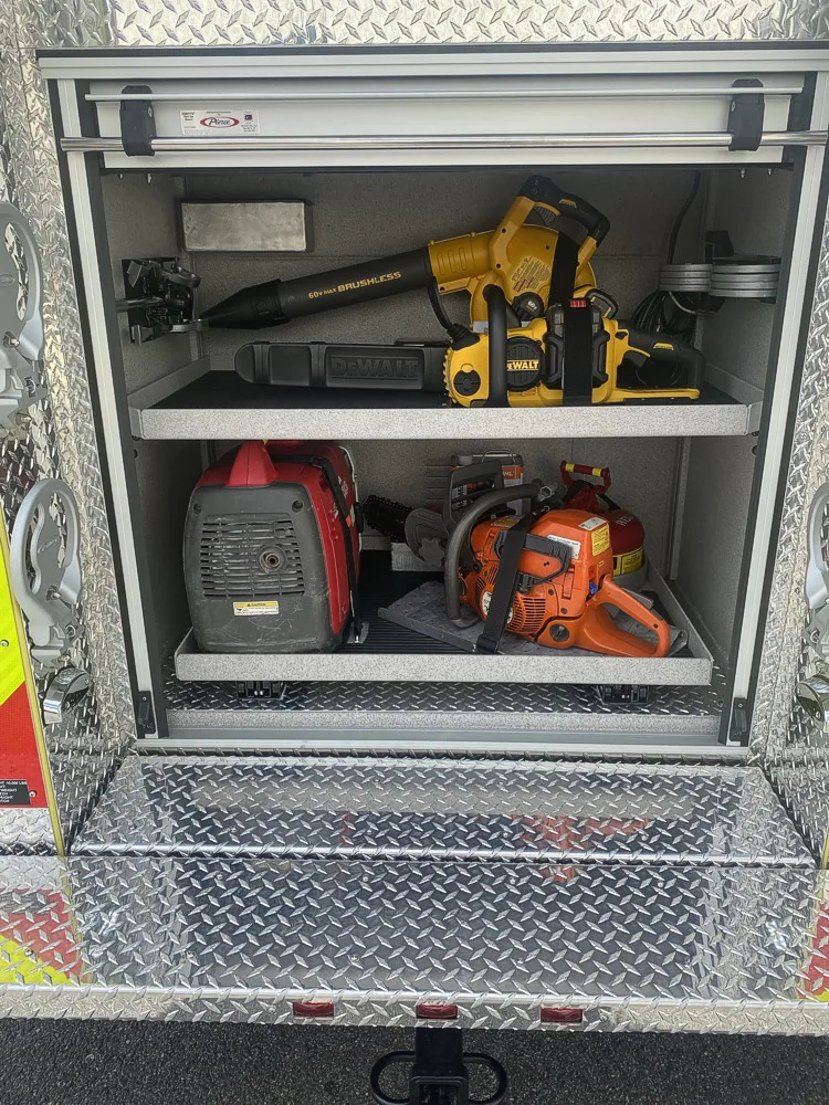 Open side compartment showing rescue saw and power-tool storage