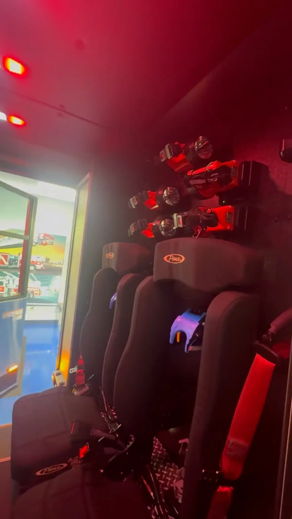 Cab interior seat area with red lighting showing seat backs and aisle