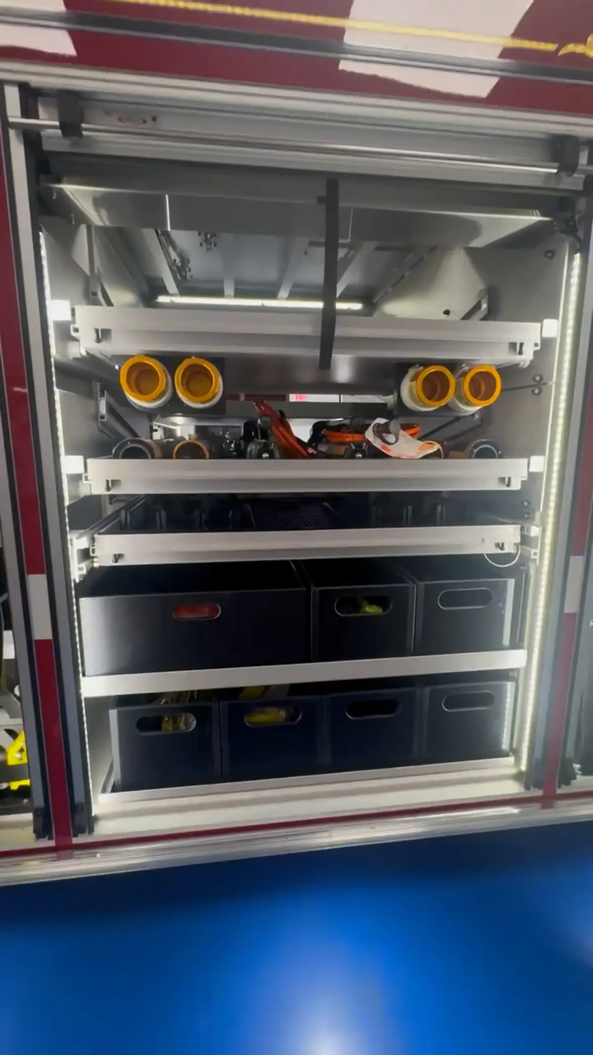 Open compartment view showing slide-out storage shelves and upper tray