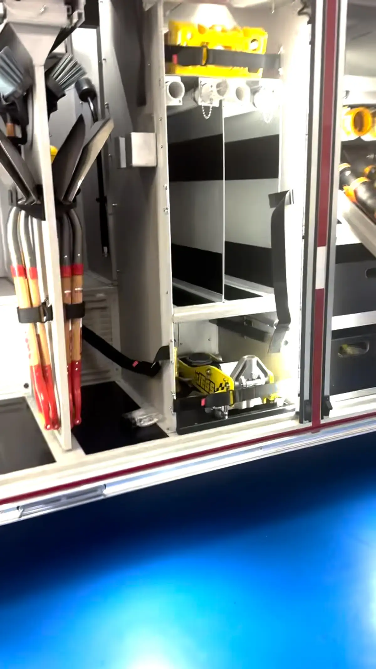 Open side compartment showing mounted hand tools and lower equipment space