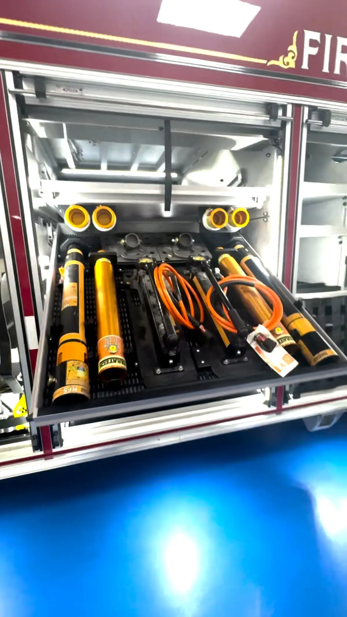 Open compartment showing rescue tools on a pull-out tray