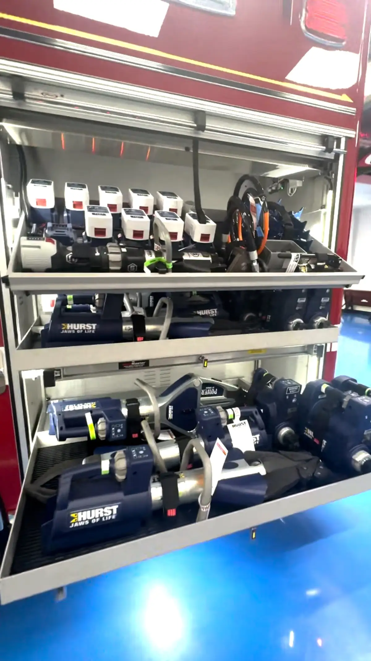 Open compartment with pull-out tray showing mounted cylinders and tools