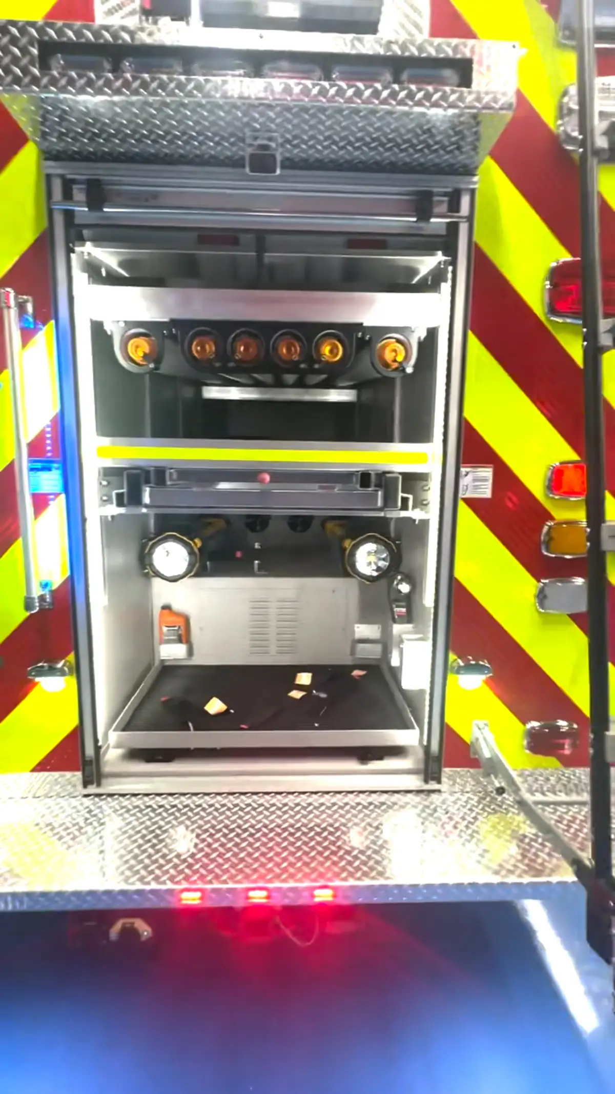 Rear center compartment open showing stacked slide-out trays on chevron panel