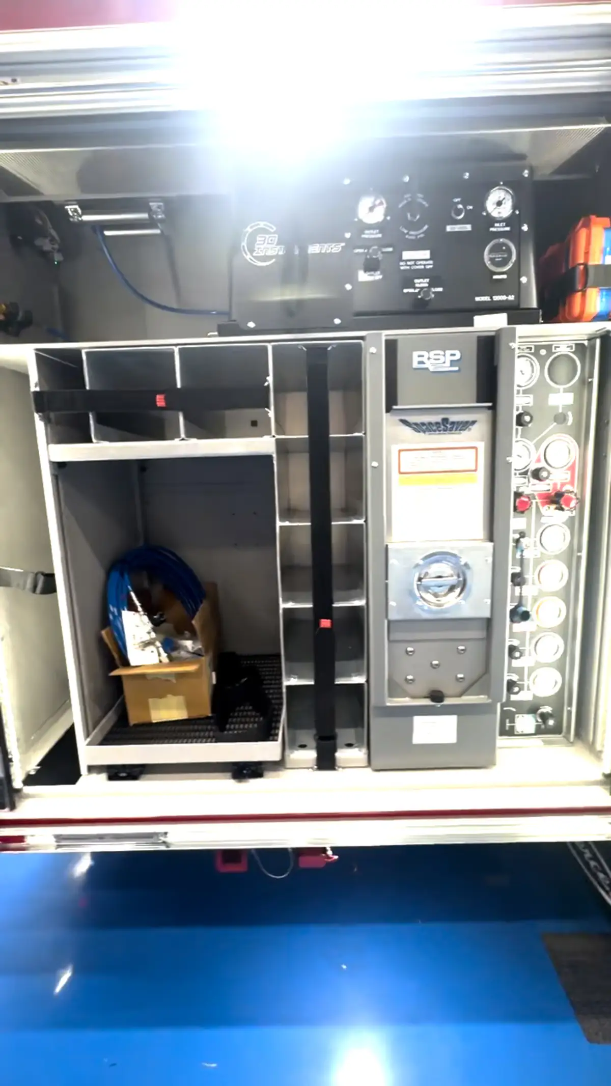 Open rear-side compartment showing shelf storage and bag compartment