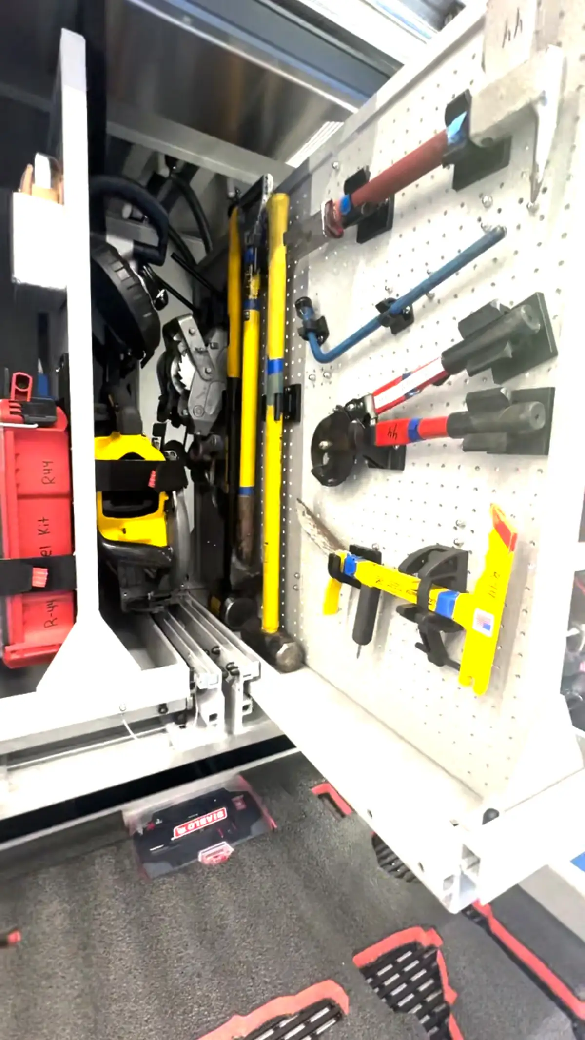 Open toolboard compartment showing mounted hand tools and clamps