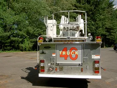 Rear view showing rear platform structure, warning lights, and rear panel