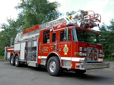 Front-left exterior view showing bumper, cab, and ladder sections