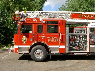 Driver-side cab and pump panel view showing controls and front wheel area