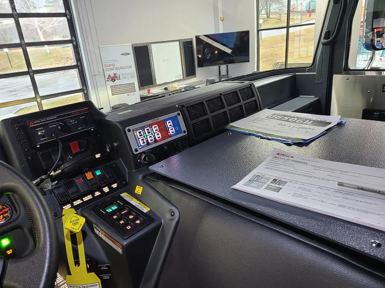 Driver cockpit view showing dashboard controls and center console