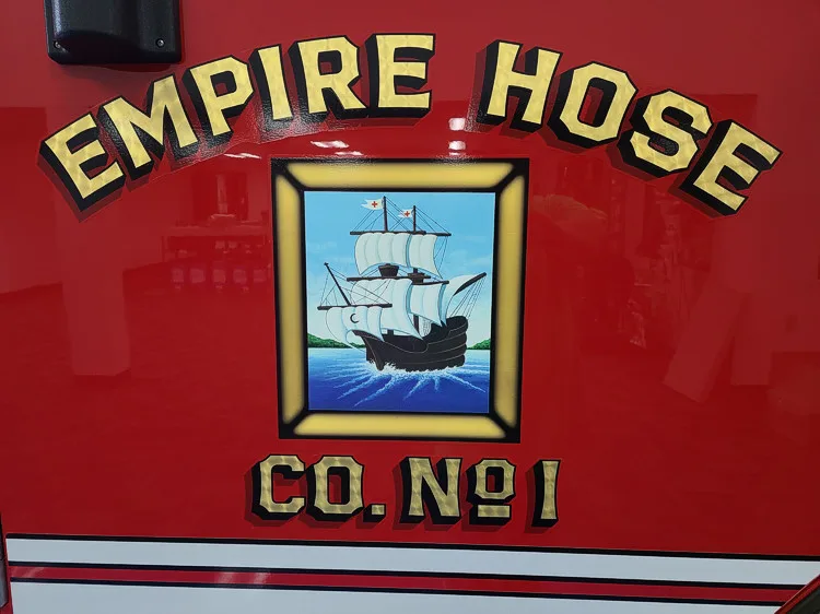 Cab door close-up showing company crest on red panel