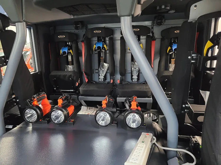 Rear crew-seat close-up showing SCBA seat backs and restraints