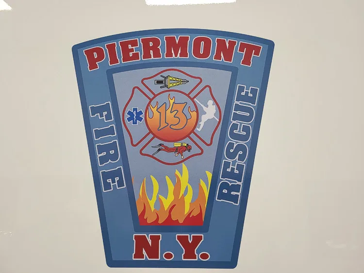 Wall-mounted shield close-up showing station patch logo