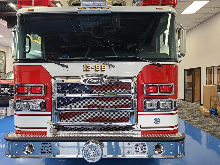 Head-on front view showing grille, bumper, and warning lights