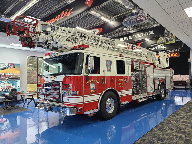 Front-left profile view showing aerial ladder sections above side body