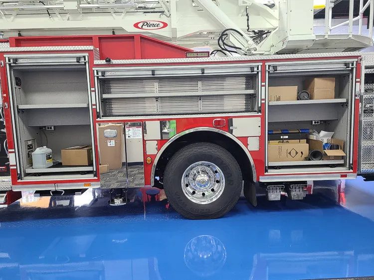 Driver-side profile showing side compartments and rear wheel area