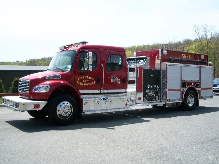 Driver-side profile view showing the open pump panel, roll-up compartments, and rear wheel area.