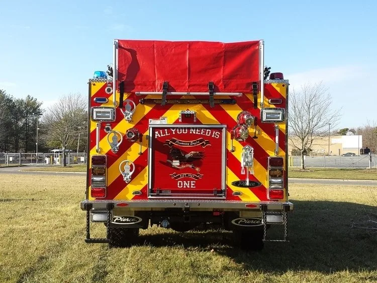 Rear exterior view showing chevrons, hosebed cover, and lower hose connections