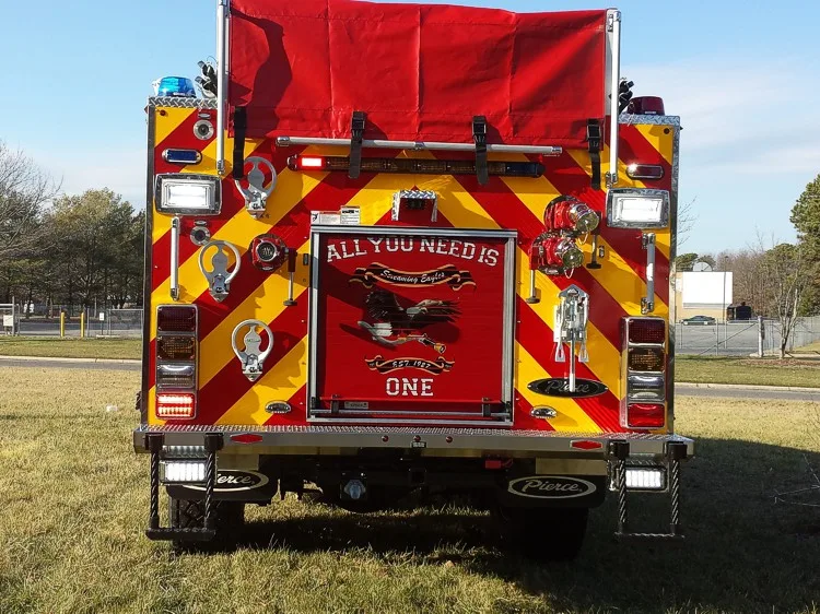 Rear view showing chevron striping, covered hosebed, and rear intake connections