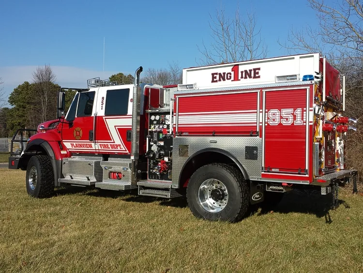 Rescue pumper passenger-side rear three-quarter view with pump panel and rear compartments