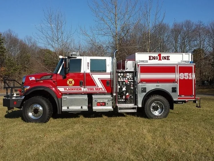 Rescue pumper driver-side profile view showing pump controls and side storage compartments
