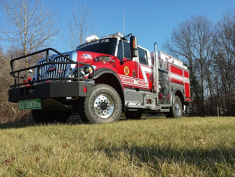 Low front-left angle showing grille guard, front wheel, and cab
