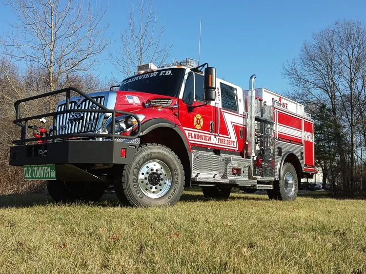 Low front-right angle showing bumper guard, cab, and side body compartments