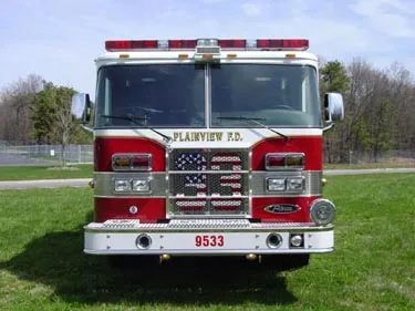Head-on front view showing grille, bumper, and warning lights