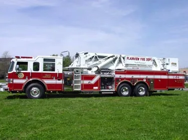 Passenger-side full profile showing tower ladder body and tandem rear axles