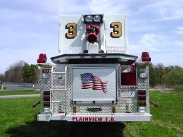 Rear view showing bucket platform, rear warning lights, and American flag panel