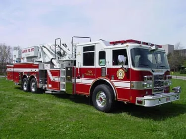 Front-right exterior view showing cab, side body, and ladder turntable area