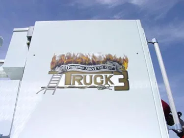 Bucket side panel close-up showing Truck 3 flame-style logo graphic