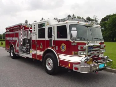 Front-left exterior view in open lot showing bumper and cab