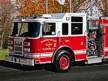 Pierce Saber pumper driver-side profile showing pump panel gauges and side compartments