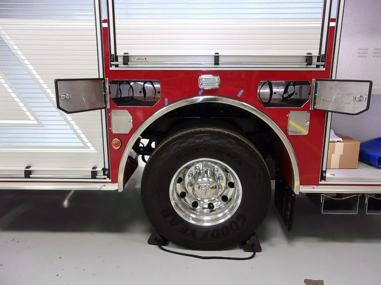 Rear wheel and lower body close-up showing tire, trim, and side panel
