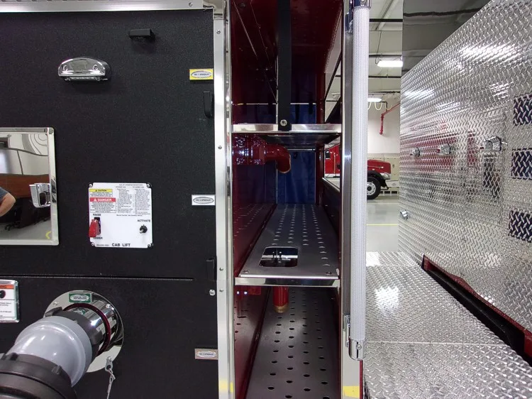 Open side compartment showing equipment canisters and shelf storage