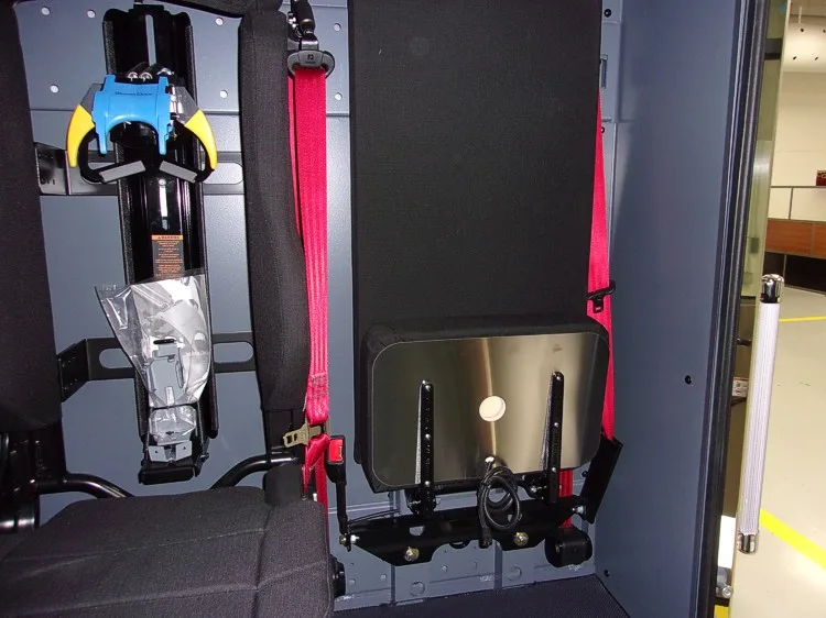 Open rear seating compartment showing mounted SCBA seat and restraint