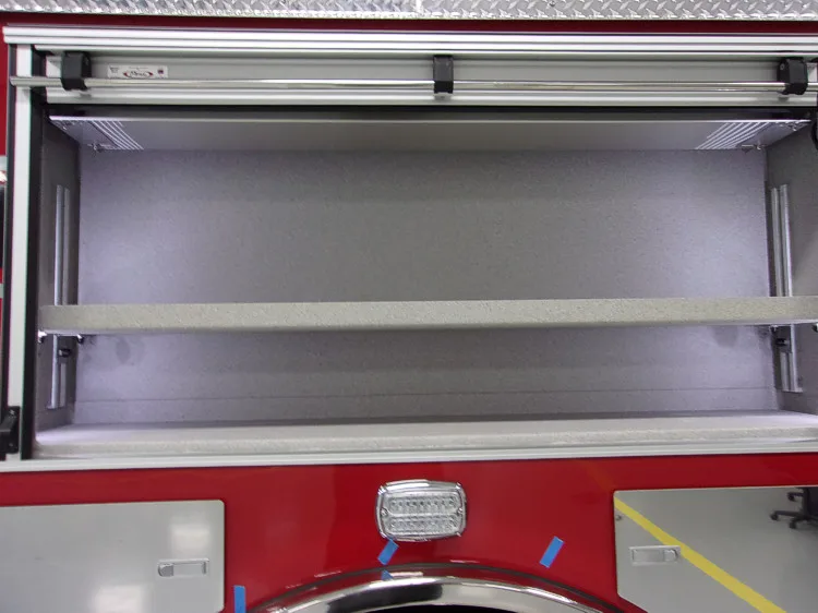 Open side compartment showing empty shelf bay with roll-up door raised