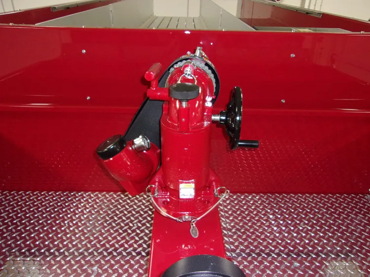 Hose connection close-up showing red hydrant fitting on diamond-plate deck