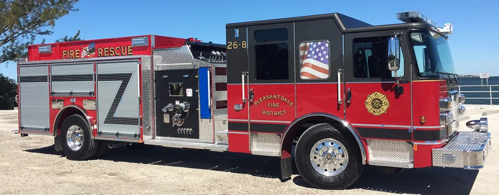 Rescue pumper front-left exterior view parked outside the station