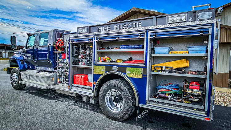 Driver-side profile with open compartments showing full equipment arrangement