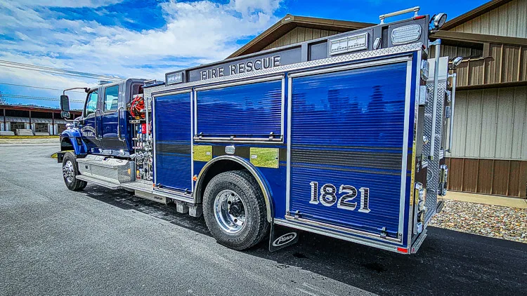 Driver-side profile view showing closed side doors and long body