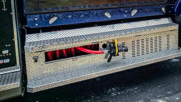 Lower side compartment close-up showing tray opening and underbody step